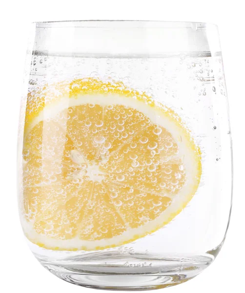 Lemon in glass of water isolated on white — Stock Photo, Image