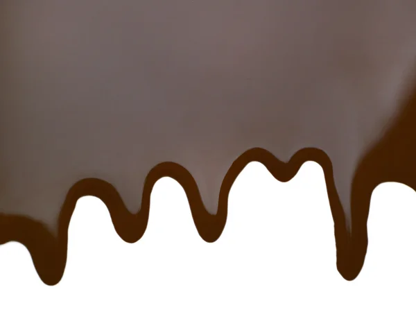 Coklat meleleh menetes di latar belakang putih — Stok Foto