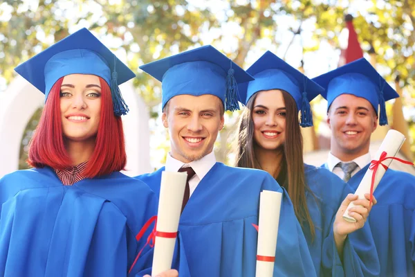 Students wearing graduation hat and gown — Stock Photo, Image