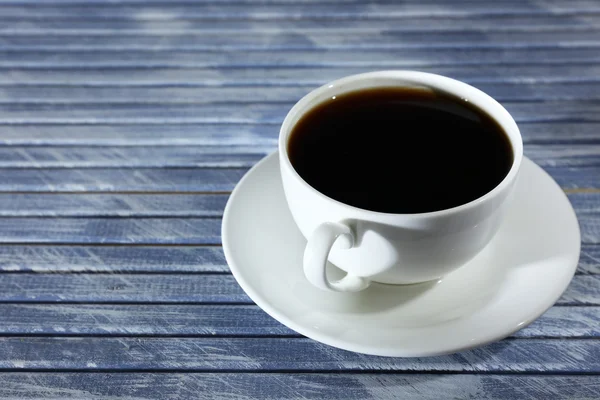 Cup of coffee on wooden table — Stock Photo, Image