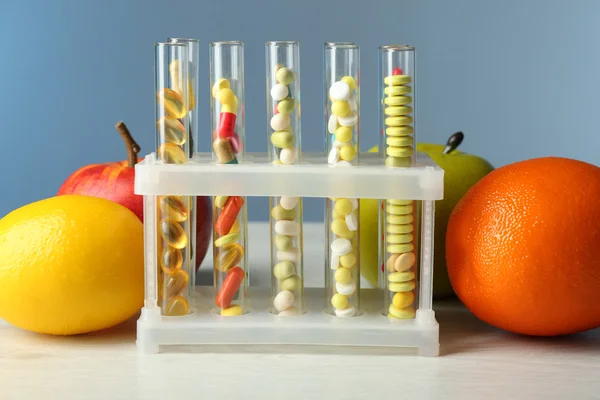 Drugs in test tubes and fruits — Stock Photo, Image