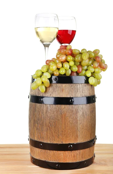 Wine in goblets and grapes on barrel on wooden table on white background — Stock Photo, Image