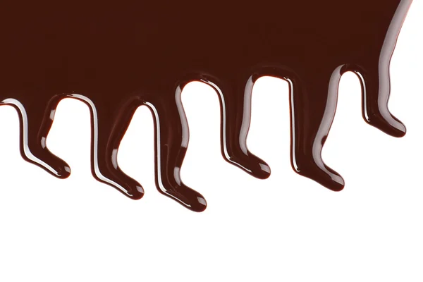 Melted chocolate dripping on white background — Stock Photo, Image