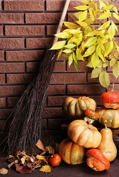 Pumpkins on stool on floor — Stock Photo, Image