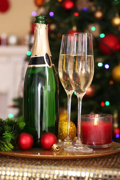 Christmas decorations and champagne bottle — Stock Photo, Image