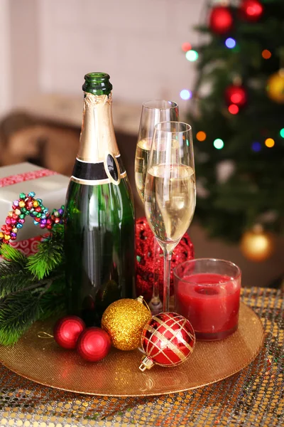 Christmas decorations and champagne bottle — Stock Photo, Image