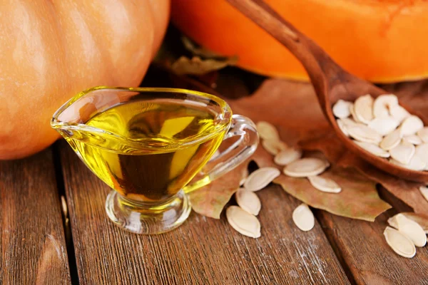 Pumpkin seed oil in glass sauce-boat — Stock Photo, Image