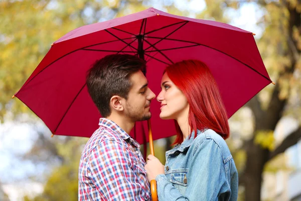 Loving couple under an umbrella — Stock Photo, Image