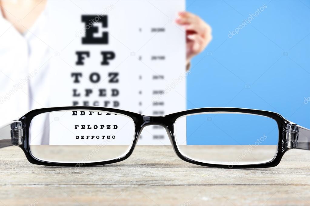 Eye glasses on wooden table