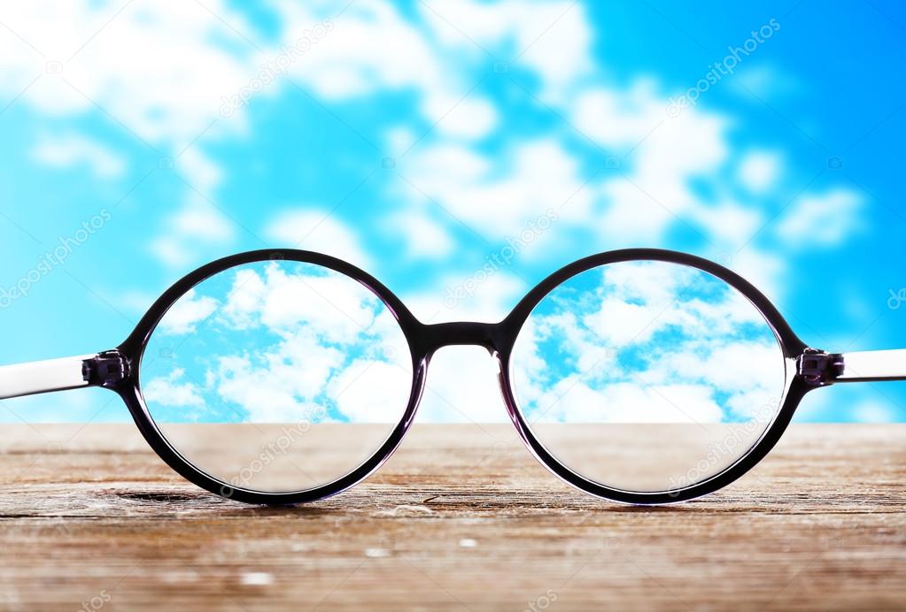 Glasses on sky background