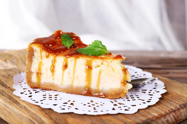 Cheese cake on paper napkin on cutting board — Stock Photo, Image