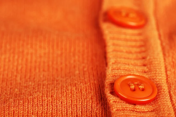 Tombol pada pakaian oranye — Stok Foto