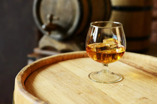 Glass of brandy in cellar — Stock Photo, Image