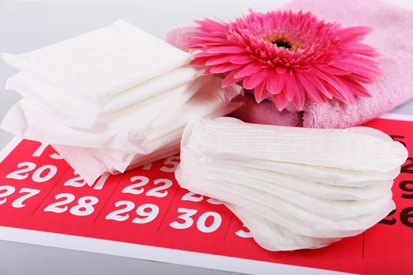 Sanitary pads and white flowers — Stock Photo, Image