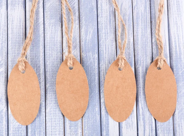 Brown tags on wooden background — Stock Photo, Image