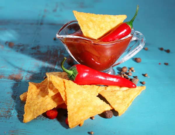 Tasty nachos and bowl with sauce — Stock Photo, Image