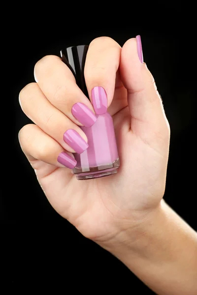 Nail polish in hand, close-up — Stock Photo, Image