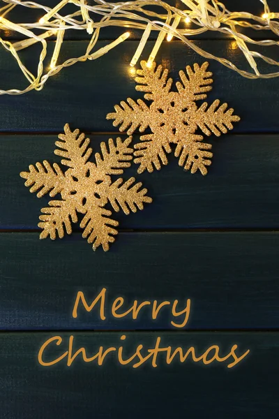 Garland and snowflakes on  wooden background — Stock Photo, Image