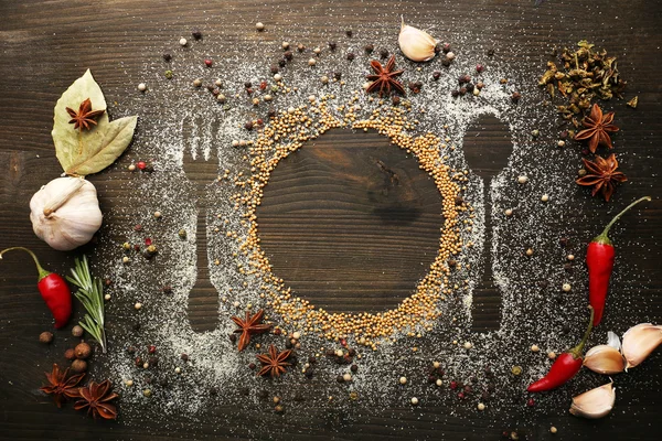 Spices on table with cutlery silhouette — Stock Photo, Image