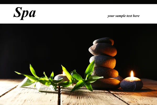 Spa stones, candles on wooden table — Stock Photo, Image