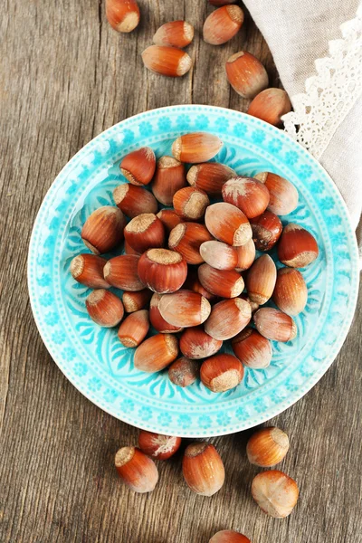 Hazelnuts in plate on table — Stock Photo, Image
