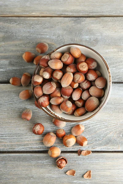 Hazelnuts in bowl on table — Stock Photo, Image