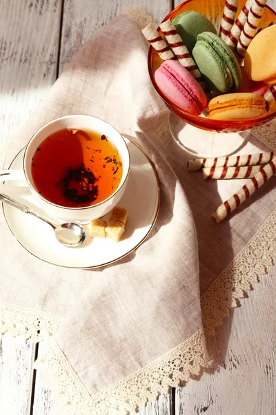 Cup of tea with macaroons on table, close up — Stock Photo, Image