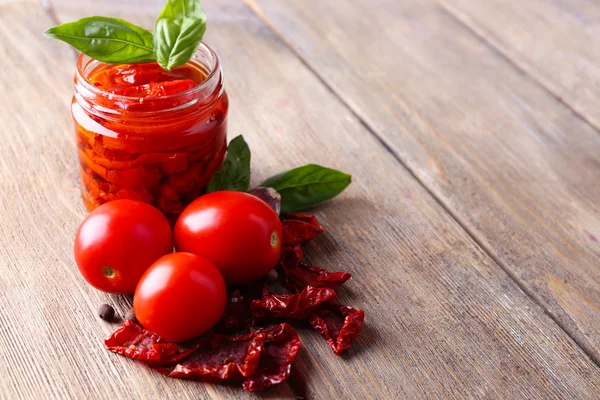 Sun dried tomatoes in glass jar — Stock Photo, Image