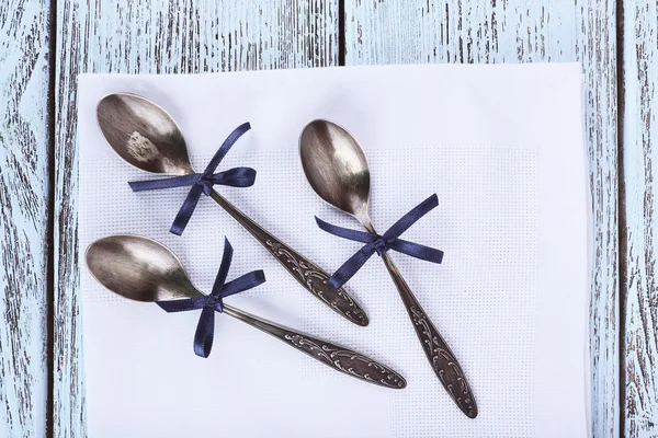 Metal spoons on white napkin