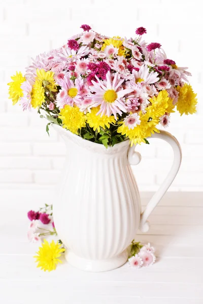 Beautiful flowers in pitcher — Stock Photo, Image