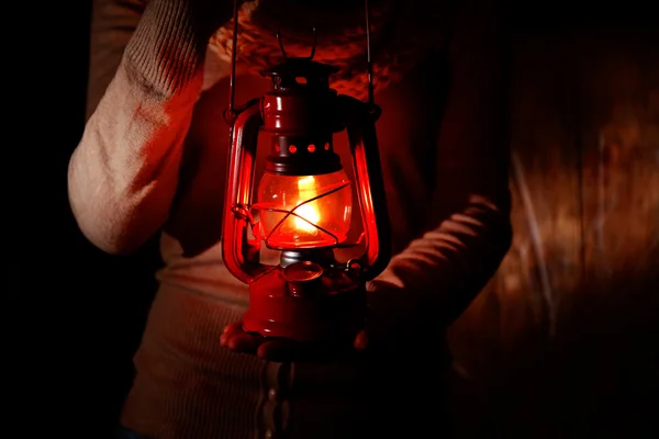 Lantern in hands in darkness — Stock Photo, Image