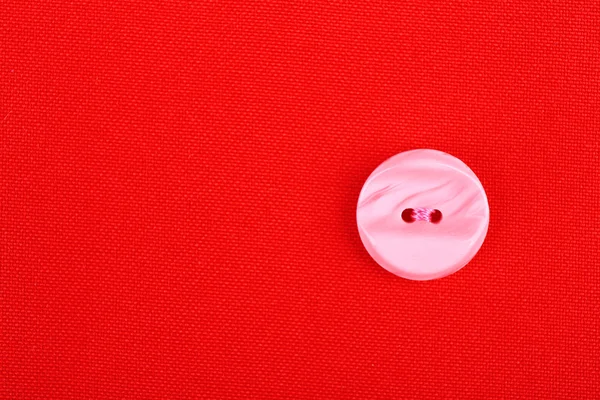 Button on red cloth, close up — Stock Photo, Image