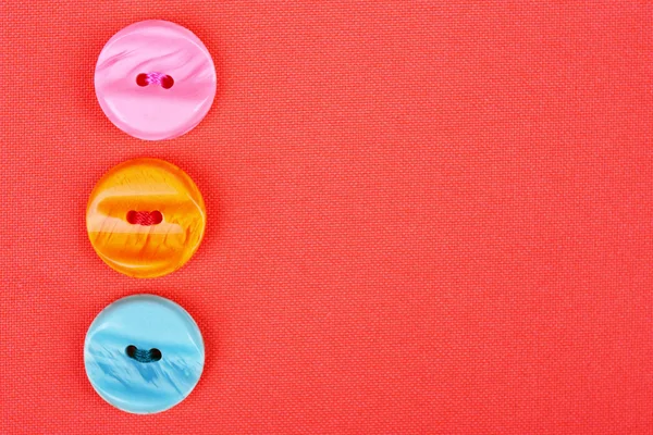 Buttons on red cloth — Stock Photo, Image