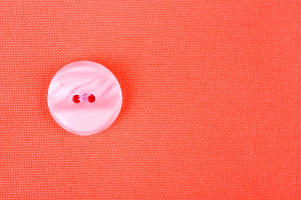 Button on red cloth — Stock Photo, Image