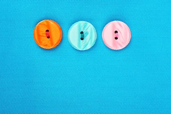 Buttons on blue cloth — Stock Photo, Image