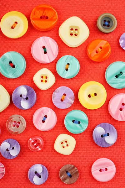 Buttons on red cloth — Stock Photo, Image