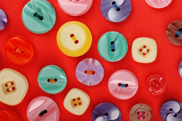 Buttons on red cloth — Stock Photo, Image