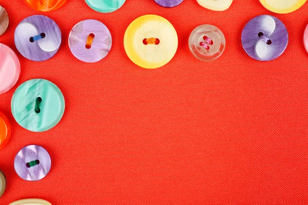 Buttons on red cloth — Stock Photo, Image