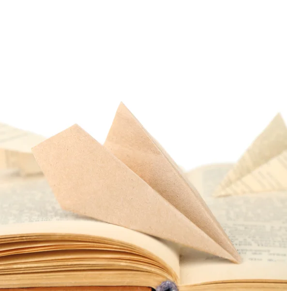 Origami airplanes on old book, on white background — Stock Photo, Image