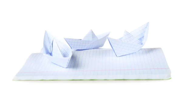 Origami boats on notebook, isolated on white — Stock Photo, Image