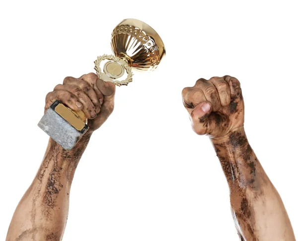 Gold cup in dirty hands — Stock Photo, Image