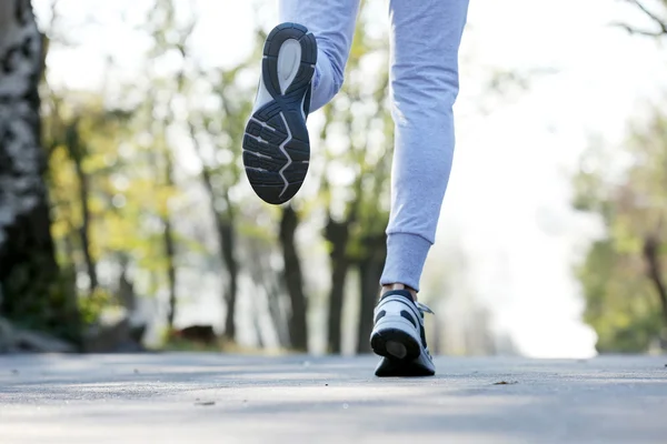 Runner's feet on road — Stock Photo, Image