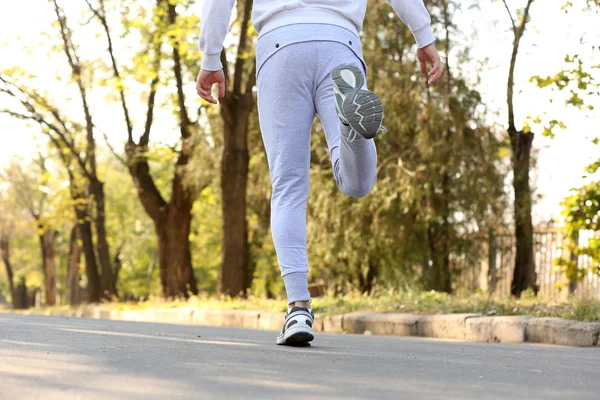 Runner 's feet on road — стоковое фото