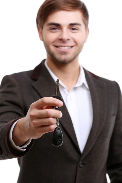 Homme d'affaires tenant clé de voiture isolé sur blanc — Photo