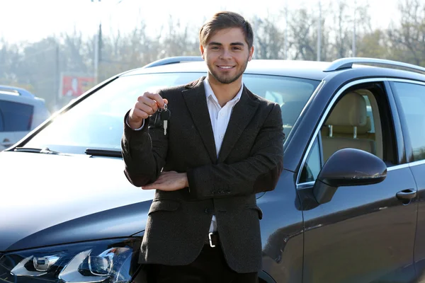 Homme d'affaires tenant la clé de voiture à l'extérieur — Photo