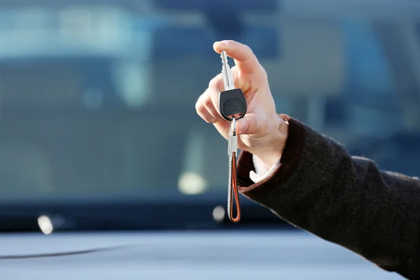 Businessman holding car key outdoors — Stock Photo, Image