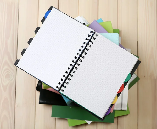 Notebook and pile of books — Stock Photo, Image