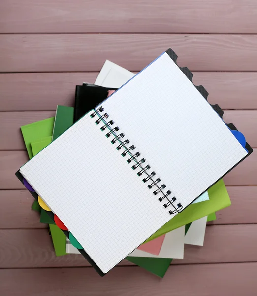 Notebook and pile of books — Stock Photo, Image