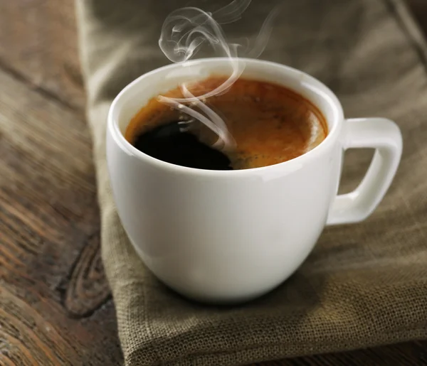 Cup of coffee on wooden table — Stock Photo, Image