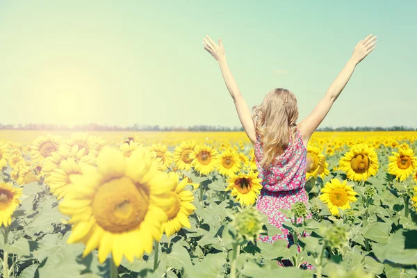 Jonge vrouw in zonnebloem veld — Stockfoto